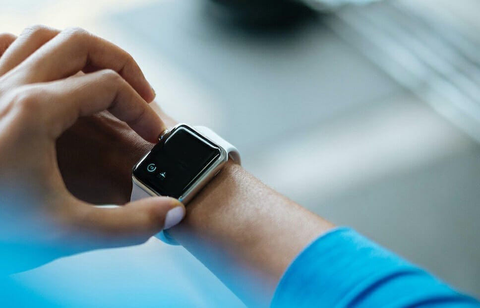 Woman logging her workout online on her watch